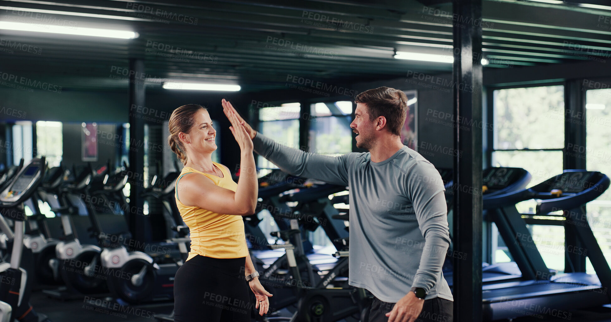 Buy stock photo Fitness, smile and high five with people in gym for motivation boost, team and support with coach. Workout club, man and woman with hands together as friends for goal or success with personal trainer