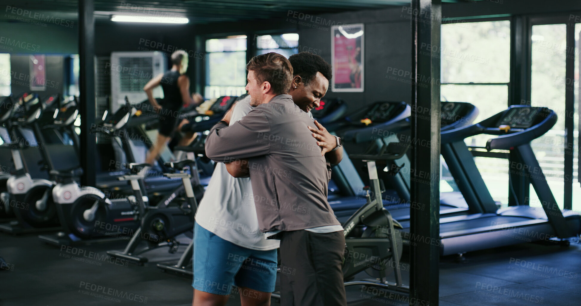 Buy stock photo Happy, men and friends in gym, hug and celebration with personal trainer for health goals or fitness. People, embrace and instructor with smile for workout milestone, athlete and support for wellness