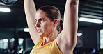 Serious, woman and weightlifting with barbell in gym for strength exercise, arm workout or power. Fitness, female person or lifting with weight for intense training or bodybuilding in health club