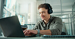 Headphones, typing and businessman with laptop in office with music for creative project with research. Computer, tech and male magazine editor with playlist for article with publishing in workplace.