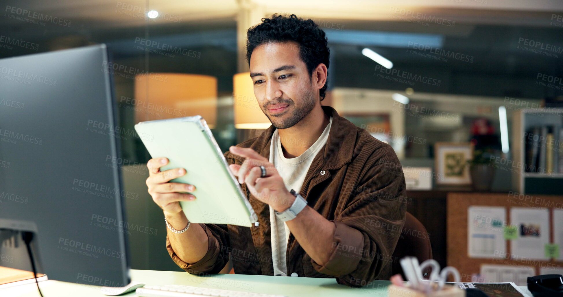 Buy stock photo Online, reading and man with tablet, office and research for campaign and working late with project. Digital marketing, social media manager and person with tech for deadline and creative at night