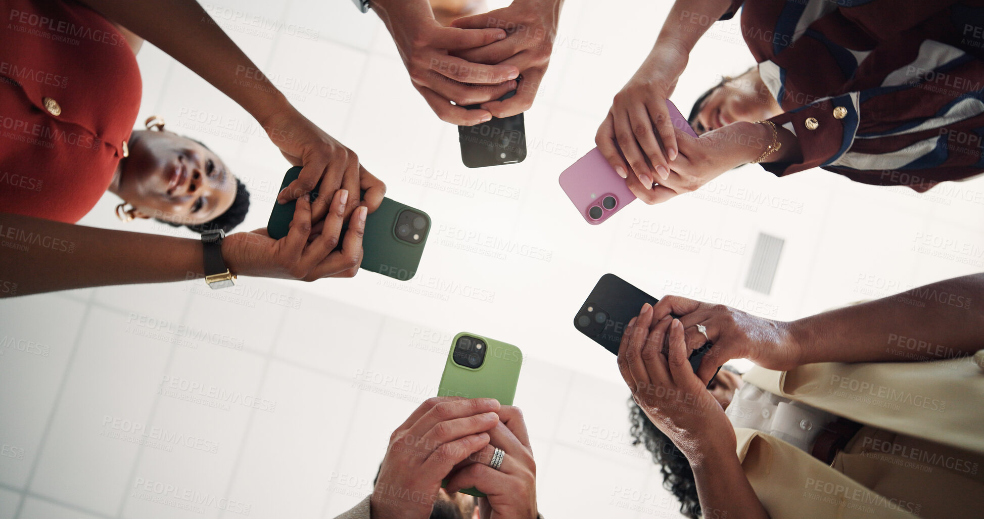 Buy stock photo Business people, hands and typing with phone in circle for data sharing or network below in office. Low angle, group or employees texthing with mobile smartphone for connectivity software or app