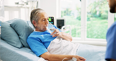 Buy stock photo Senior woman, drinking water and doctor by hospital bed, rest and recovery with hydration for wellness. Elderly person, medical worker and glass with liquid, detox and support for healing at clinic