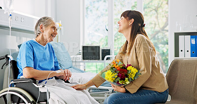 Buy stock photo Hospital, flowers and woman with mother in wheelchair for support, comforting and gift for surgery recovery. Healthcare, family and person with bouquet for elderly mom for healing, wellness and love