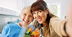 Selfie, smile and senior mother with daughter in hospital for love, flowers and rehabilitation visit. Photography, support and medical patient with portrait of people in clinic for hug and bouquet