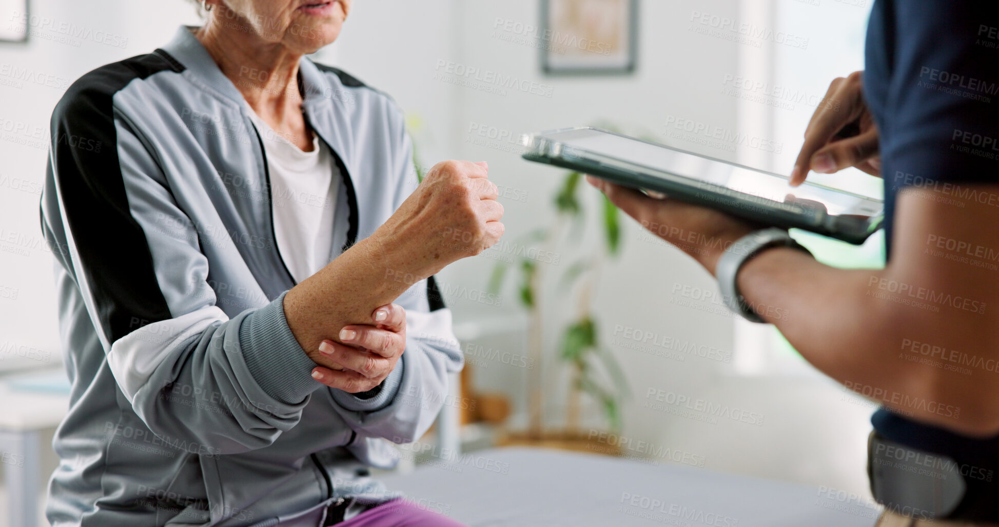 Buy stock photo Physiotherapy, tablet and hands with old woman in clinic for wrist pain, rehabilitation and discussion. Online medical report, physical therapy progress and advice with people for osteoarthritis