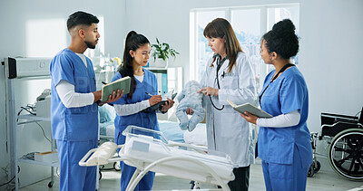 Buy stock photo Doctor, nurses and child doll in clinic for training, research and teamwork or management. Healthcare professionals, people and pediatrician with baby model for internship, cardiology or discussion