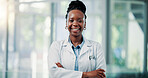 Happy, black woman and portrait of doctor in hospital with confidence for medical career and support. Smile, professional and African female healthcare worker with pride for job development in clinic