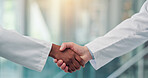 Shaking hands, doctors and welcome in hospital, lobby and thanks with agreement for hiring. People, medical staff and handshake for success, recruitment or deal with onboarding in clinic hallway