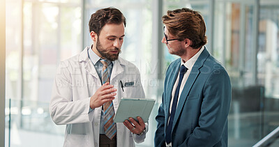 Buy stock photo Doctors, men and tablet with review at clinic, insight and discussion with planning in lobby. People, hospital director and team with tech, app and checklist with report for healthcare services