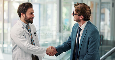 Buy stock photo Men, doctors and shaking hands at clinic, lobby and happy with agreement, thanks or hiring. People, medical staff and handshake for success, goal or congratulations for onboarding in hospital hallway