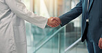 Shaking hands, doctors and recruitment at hospital, lobby and thanks with agreement for hiring. People, medical staff and handshake for success, welcome or deal with onboarding in clinic hallway