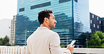 Real estate, thinking and man in city, smartphone and back with commute, opportunity and internet. Outdoor, realtor or Asian person with cellphone, decision or email for property investment or choice