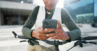 Buy stock photo Business, hands and phone with black woman in city to search for directions or travel to work. App, bicycle commute and flare with African employee typing in urban town for net zero transport