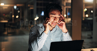 Buy stock photo Man, headache and phone call at night with startup, stress and laptop for contact or talk at media company. Person, editor or writer with smartphone, insight or burnout on overtime at creative agency