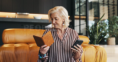 Buy stock photo Woman, reading and phone in home with passport for booking flight, VISA application or travel planning. Mature person, check ID or document with tech, website and registration for international trip.