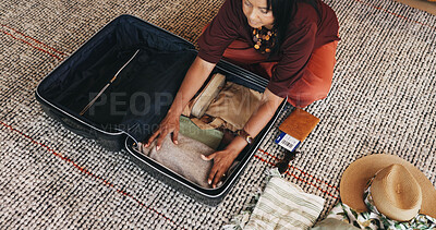 Buy stock photo Woman, travel and packing with suitcase for flight booking, holiday or vacation above in home. Female person, traveler or getting ready with clothing, luggage or passport for getaway trip in house