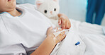 Hands, sick and child with iv drip in hospital bed for medication, hydration and treatment. Kid, teddy bear and liquid infusion for medical recovery, sedation and sleeping with healthcare supplements