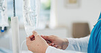 Hands, tube or iv bag in hospital for healthcare, drip treatment or medication infusion for wellness. Set up, nurse or person with medical equipment for patient care, antibiotics or electrolytes line