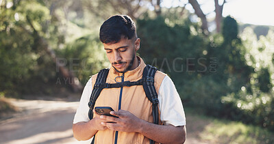 Buy stock photo Hike, chat or man in forest with phone, message alert or location share in summer hobby. Trekking, network or male person in nature with tech, notification check or journey update on social media.