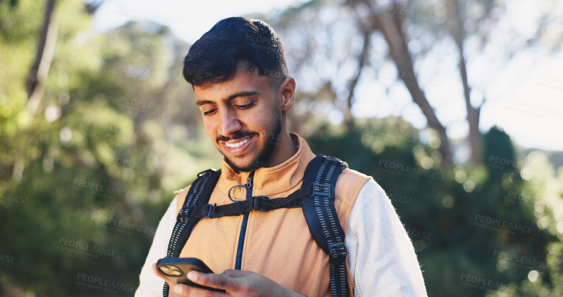 Buy stock photo Hiking, chat or man in forest with phone, message alert or location share in summer hobby. Trekking, space or male person in nature with tech, notification check or journey update on social media.