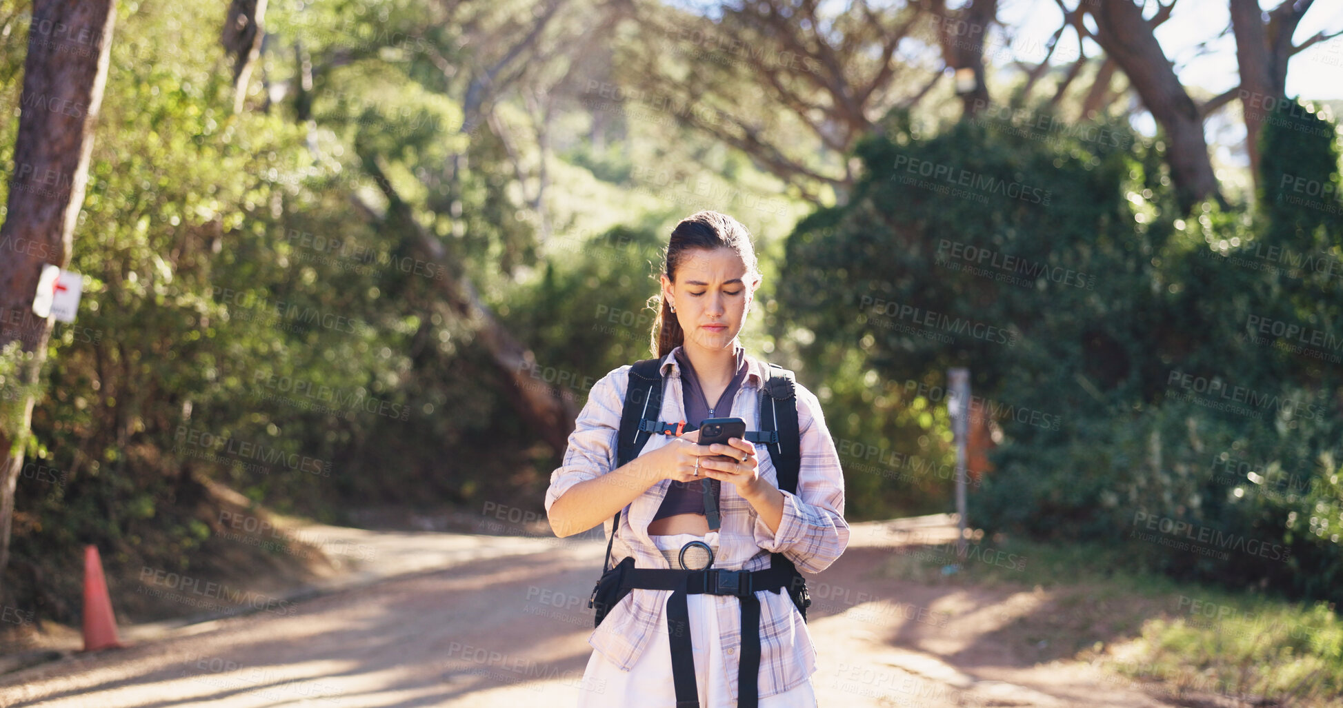 Buy stock photo Phone, reading and woman on path for hiking, navigation and guide in online direction. Travel, route and female person in nature with tech, map tracking and location search on outdoor adventure.