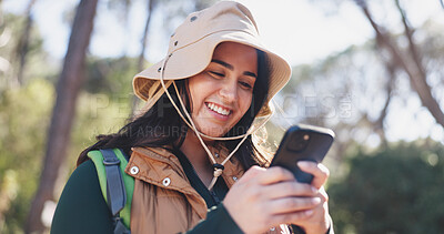 Buy stock photo Hiking, chat or woman in forest with phone, message alert or location share in summer hobby. Trekking, bokeh or person in nature with tech, notification check or journey update on social media.