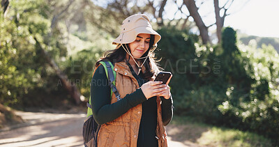 Buy stock photo Hiking, chat or woman in nature with phone, message alert or location share in summer hobby. Trekking, typing or female person on path with tech, notification check or journey update on social media.