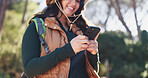 Hiking, low angle or woman in nature with phone, message alert or location share in summer hobby. Trekking, bokeh or person on path with tech, notification check or journey update on social media.