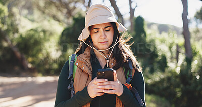 Buy stock photo Hike, chat or woman in woods with phone, message alert or location share in summer hobby. Trekking, bokeh or female person in nature with tech, notification check or journey update on social media.