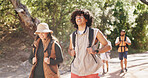 Hiking, smile and travel with couple of friends outdoor in forest for hobby or journey. Backpack, trekking and walking with group of happy hikers on trail in nature together for adventure or fitness