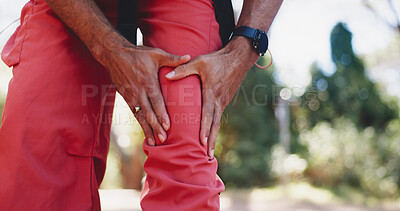 Buy stock photo Hiker, hand and hurt with knee pain, forest and person with muscle tension on adventure and outdoor. Hiking, accident and traveler with injury in nature, travel and massage for inflammation or sore