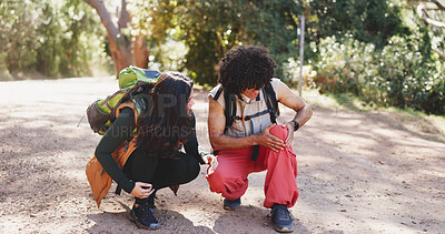 Buy stock photo Man, knee pain and hiking with partner in forest for adventure with fatigue, injury or discussion on trail. People, talk and sore joint with stress, inflammation and rest with burnout with trekking