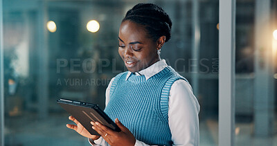 Buy stock photo Night, smile or black woman in office with tablet, draft edit or source feedback for article. Bokeh, reading or journalist in agency with tech, fact check or industry research in late shift.