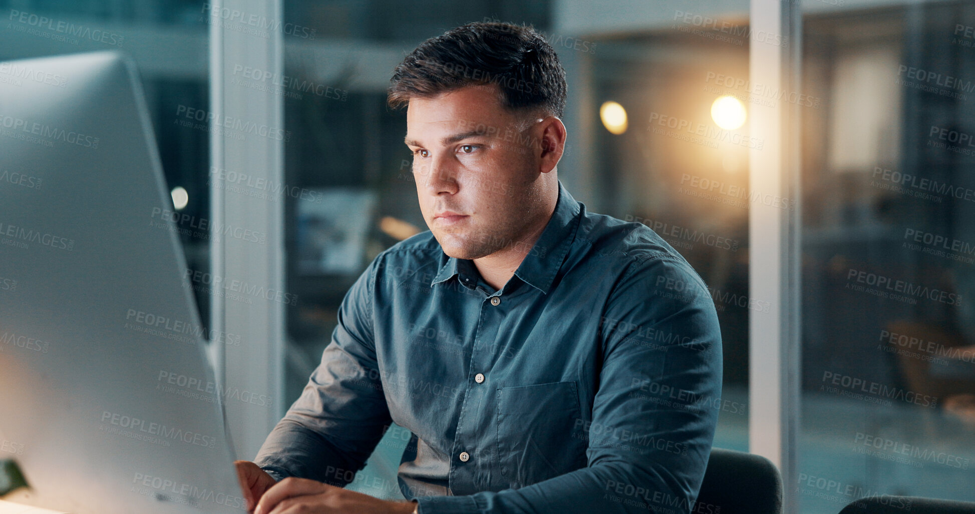 Buy stock photo Office, man and typing on computer at night for story draft, editing article or publication deadline. Journalist, person or tech at publishing agency for breaking news coverage or newsletter research