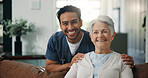 Hug, portrait and smile of old woman with nurse on sofa in living room of home for healthcare. Medical, support or wellness with male caregiver embracing senior patient in apartment for trust