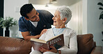 Reading, home and caregiver with senior woman with hobby for assisted living, help and volunteer. Retirement, support and happy man check up on elderly person with literature, novel or book to relax 