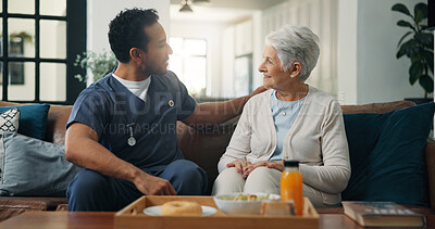 Buy stock photo Nurse, man and senior woman with breakfast on sofa for conversation, support or nutrition at house. People, caregiver and smile on couch with elderly patient, assisted living and food at nursing home