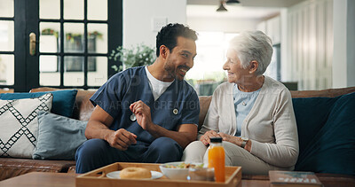 Buy stock photo Nurse, man and old woman with breakfast on sofa for conversation, support or nutrition at house. People, caregiver and smile on couch with elderly patient, assisted living and food at nursing home