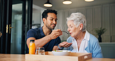 Buy stock photo Nurse, man and feeding breakfast with old woman for assisted living, support or nutrition at house. People, caregiver and helping hand with elderly patient, meal and food for diet at nursing home