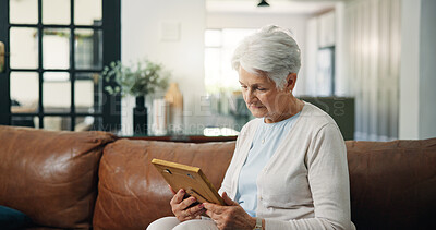 Buy stock photo Senior woman, photo frame and sad on sofa with memory, grief and nostalgia in lounge at house. Elderly patient, picture and remember with depression, mental health and broken hearth in living room