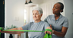 Physiotherapy, resistance band and help old woman in home, strength training or exercise. Senior person, physical therapy and assistance for muscle recovery, rehabilitation or fitness in retirement