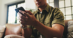 Hands, home and man on sofa, smartphone and message to contact, relax and online reading. Apartment, email and person on couch, cellphone and digital app for social media, internet and communication