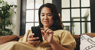 Buy stock photo Smile, woman and relax with phone at sofa for communication, social media and browsing website. Female person, rest and mobile for reading chat on app, download games and message notification in home