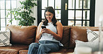 Woman, phone and smile on sofa with typing, communication or texting in home. Girl, tech and contact in living room with connection, social media update or weekend planning on couch with networking
