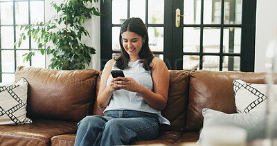 Buy stock photo Woman, phone and smile on sofa with typing, communication or texting in home. Girl, tech and contact in living room with connection, social media update or weekend planning on couch with networking