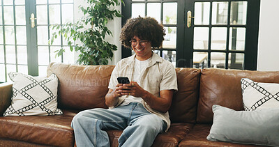 Buy stock photo Man, phone and happy with texting on couch with web chat, contact or online dating in living room at home. Person, smartphone and smile with scroll, mobile app and social network on sofa at apartment