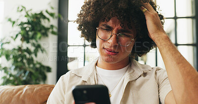 Buy stock photo Confused, man and scroll in home with phone, social media glitch and upload problem for online post. Person, doubt and reading alert on sofa with tech, text message or notification for network error.