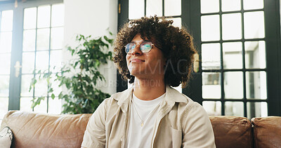 Buy stock photo Man, smile and thinking on sofa with in home with reflection, relax and glasses on break in lounge. Person, happy and perspective on couch with inspiration, memory or daydream in living room at house
