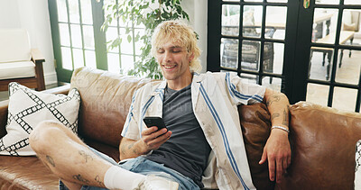 Buy stock photo Relax, couch and happy man with phone for browsing, internet website and connection for playing games. Mobile app, digital entertainment or gamer with typing for cheat command, virtual world and home